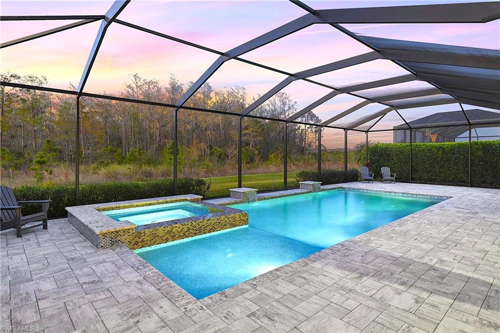 19074 Elston Way Estero, FL 33928 - Photo 5 of 50 a view of a backyard with a patio and swimming pool