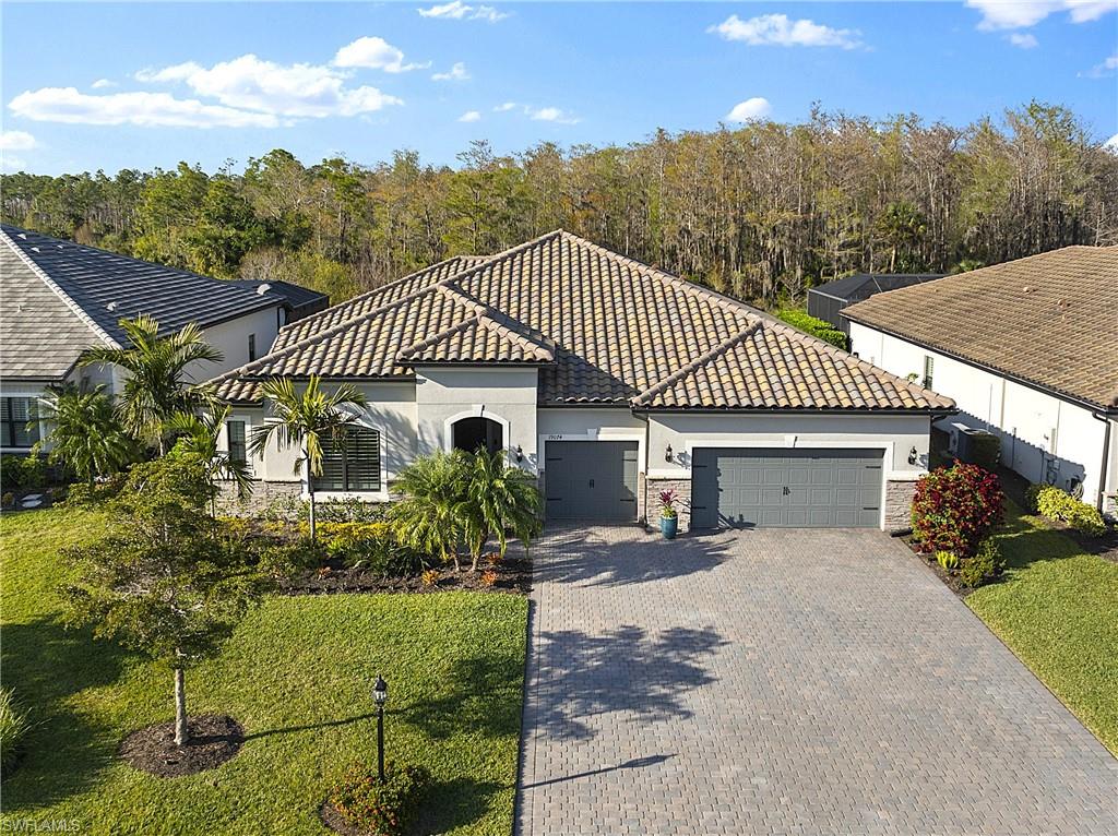 19074 Elston Way Estero, FL 33928 - Photo 7 of 50 a front view of a house with a yard