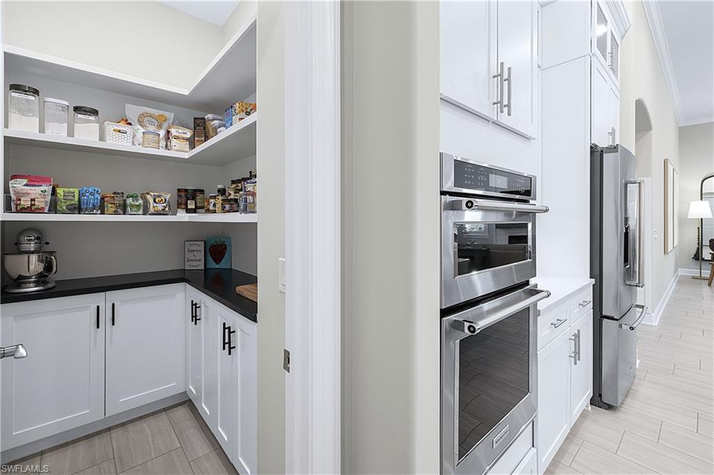 19074 Elston Way Estero, FL 33928 - Photo 10 of 50 a kitchen with granite countertop a refrigerator and a sink