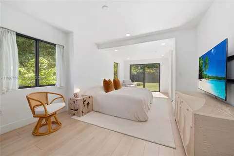 a bedroom with a bed and chair