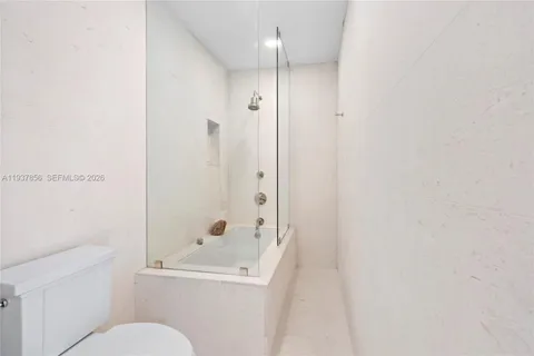 a bathroom with a toilet and shower
