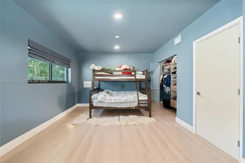 a living room with furniture and a baby crib