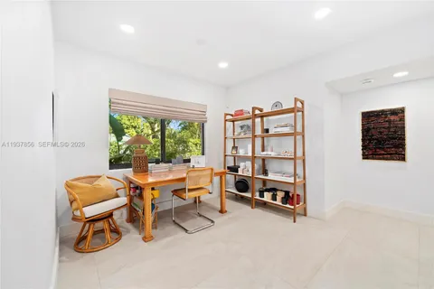 a reading room with furniture and a large window