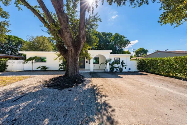 a view of a white house with a yard
