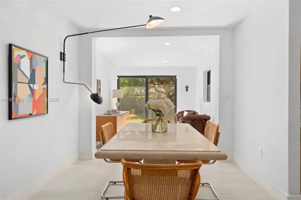 a view of a dining room with furniture and window