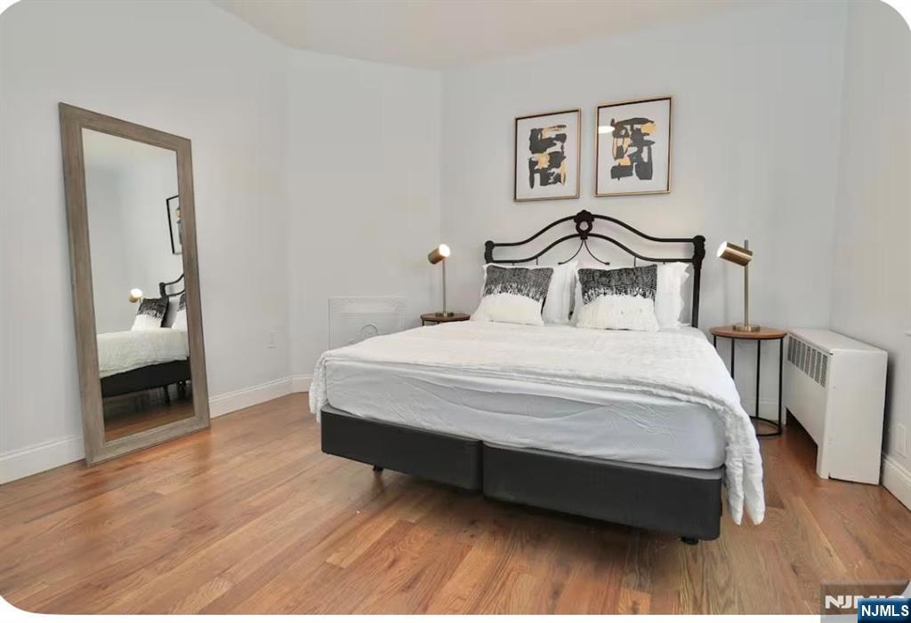 125 Malvern Street Newark, NJ 07105 - Photo 11 of 19 a bedroom with a bed and a view of bathroom