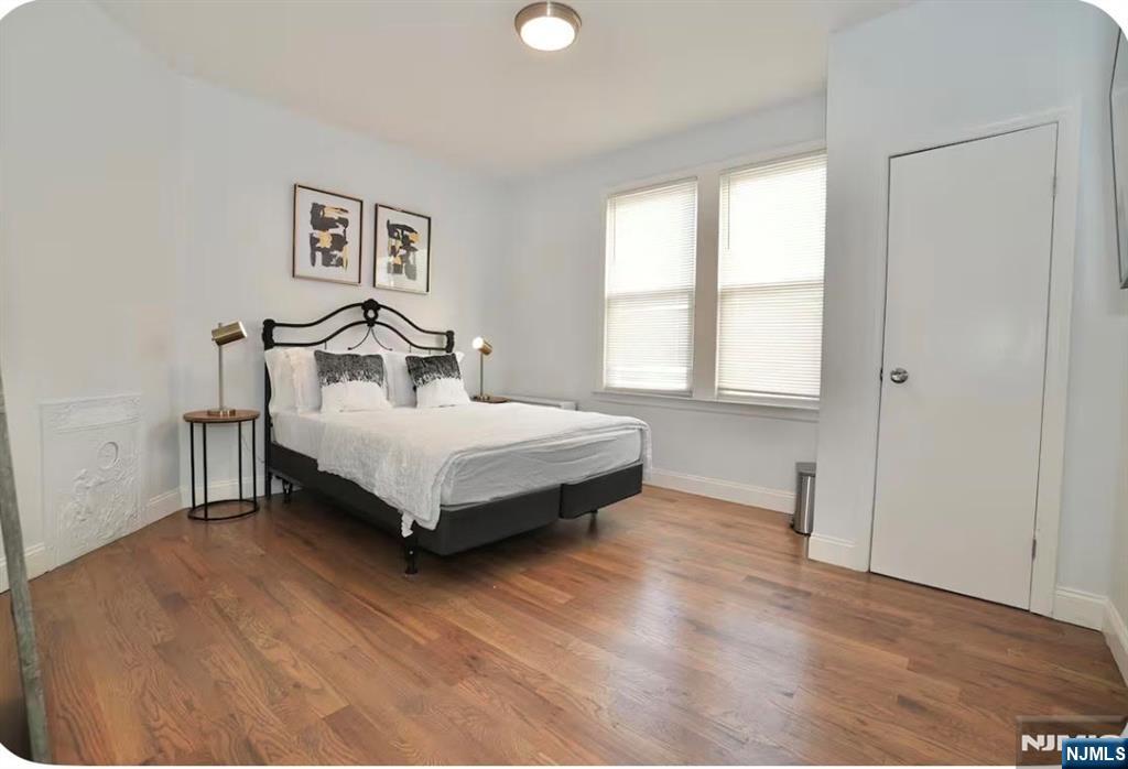 125 Malvern Street Newark, NJ 07105 - Photo 12 of 19 a bedroom with a bed and window