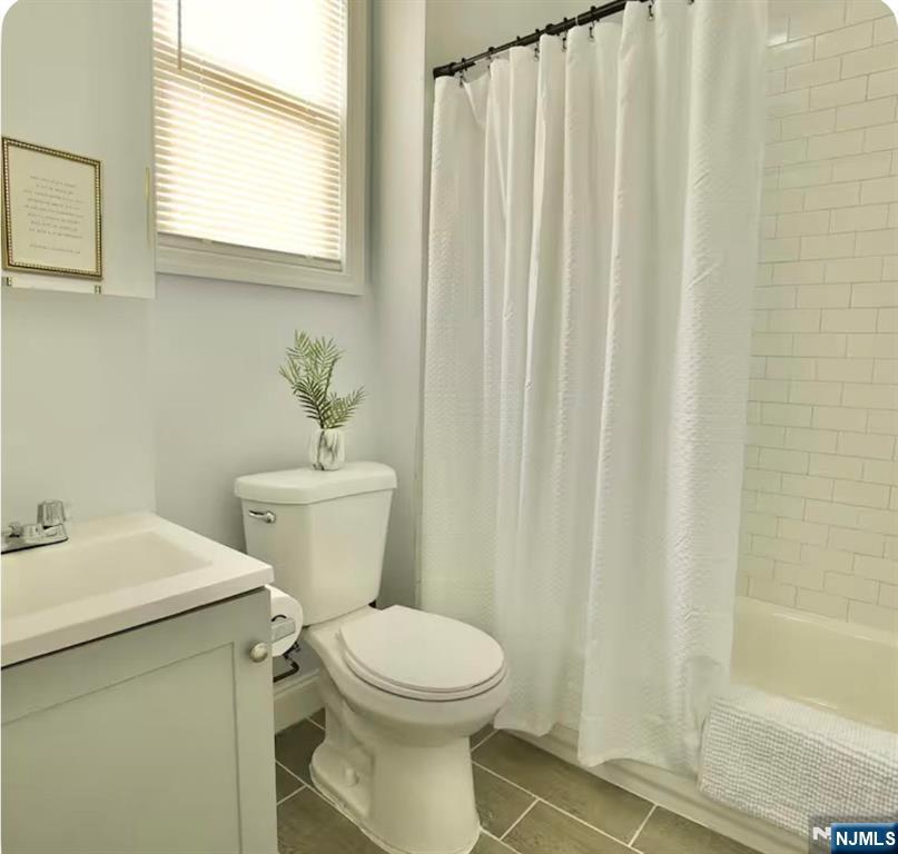 125 Malvern Street Newark, NJ 07105 - Photo 13 of 19 a bathroom with a sink a toilet and a mirror