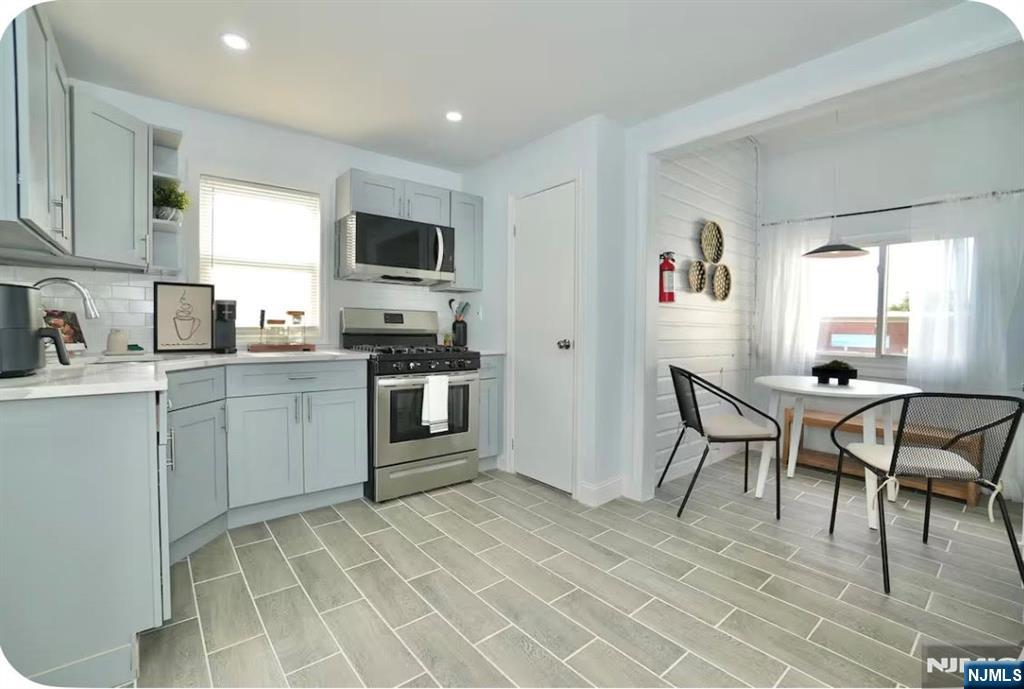 125 Malvern Street Newark, NJ 07105 - Photo 4 of 19 a kitchen with cabinets and chairs