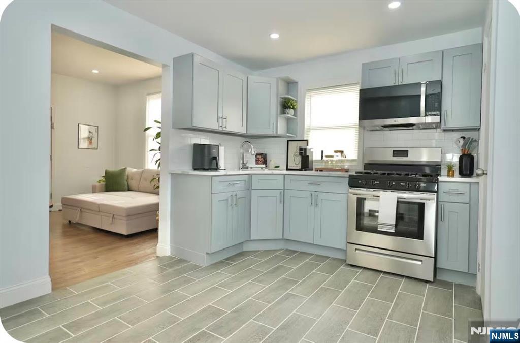 125 Malvern Street Newark, NJ 07105 - Photo 6 of 19 a kitchen with a stove a sink and a microwave