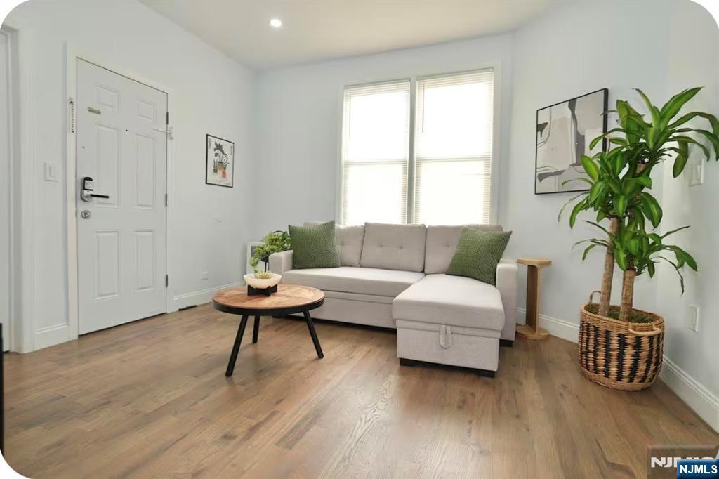 125 Malvern Street Newark, NJ 07105 - Photo 8 of 19 a living room with furniture a potted plant and a large window