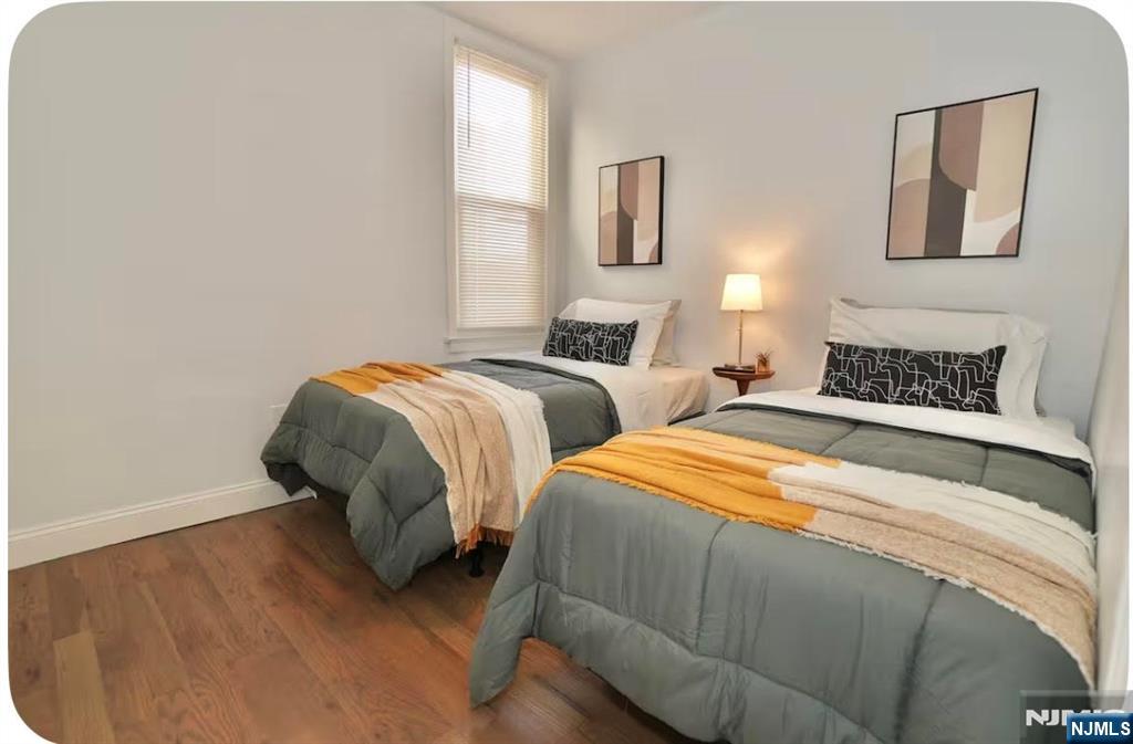 125 Malvern Street Newark, NJ 07105 - Photo 10 of 19 a bedroom with two beds and painting on the wall