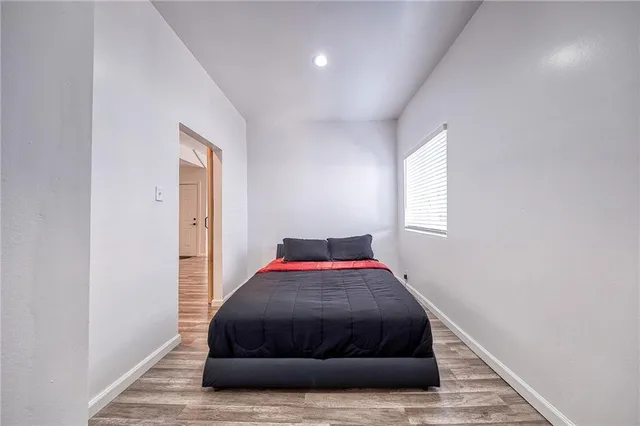 a bedroom with a bed and window