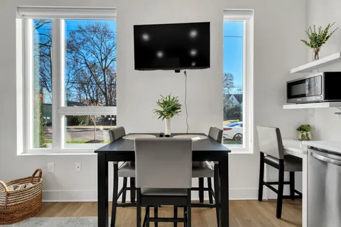 a view of a dining room with furniture and wooden floor