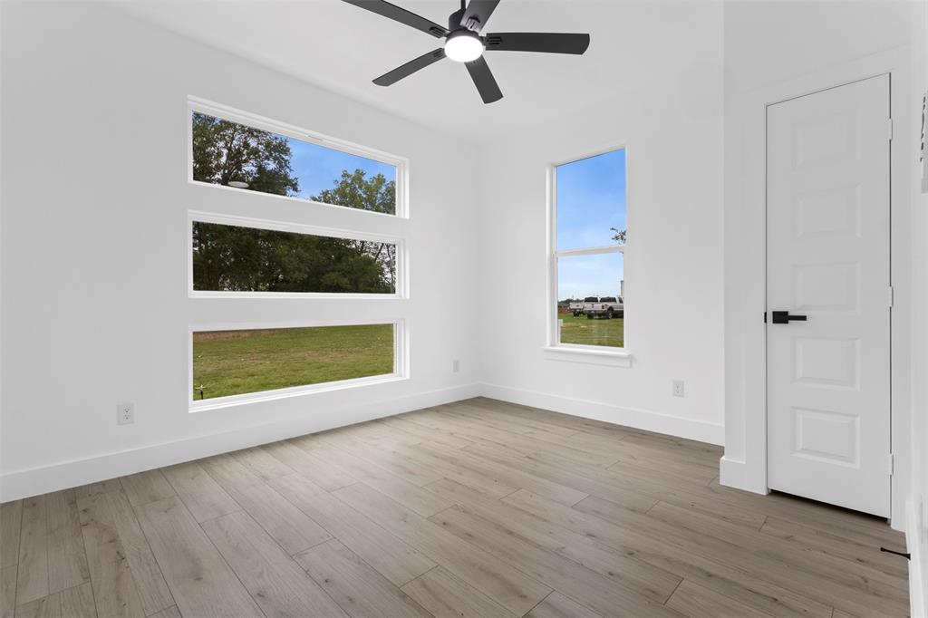 180 County Road 2245 Emory, TX 75440 - Photo 18 of 34 a view of an empty room with wooden floor and a window