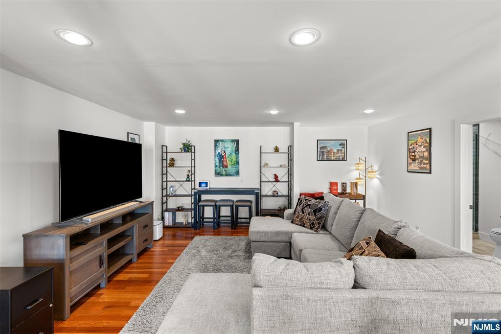 7 Oakdene Terrace, Unit 7 Edgewater, NJ 07020 - Photo 8 of 30 a living room with furniture and a flat screen tv
