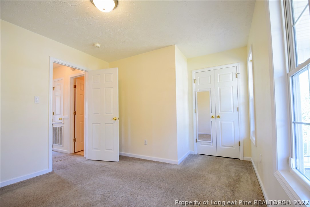 885 Ridge Road Fayetteville, NC 28311 - Photo 13 of 21 an empty room with closet and a bathroom