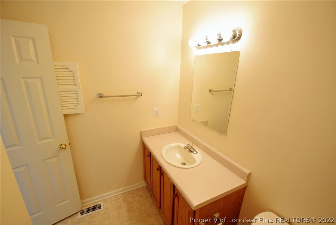 885 Ridge Road Fayetteville, NC 28311 - Photo 18 of 21 a bathroom with a sink and a mirror