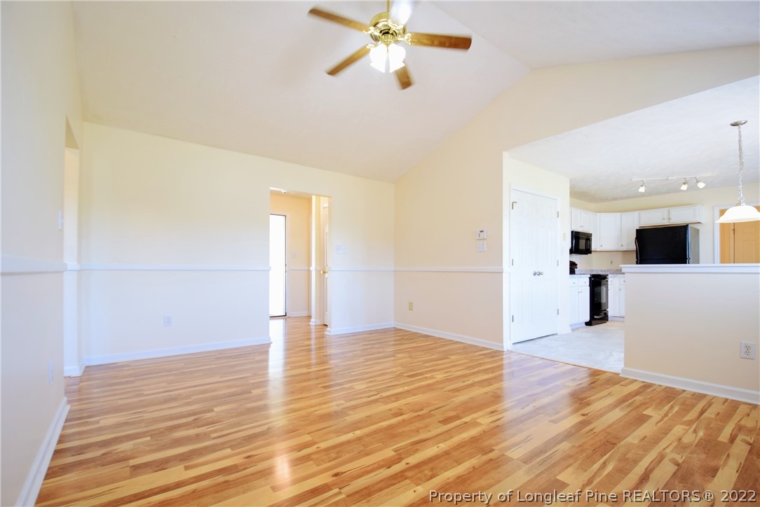 885 Ridge Road Fayetteville, NC 28311 - Photo 4 of 21 a view of a room with wooden floor and white walls