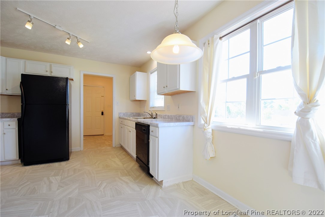 885 Ridge Road Fayetteville, NC 28311 - Photo 6 of 21 a kitchen with a refrigerator and a window