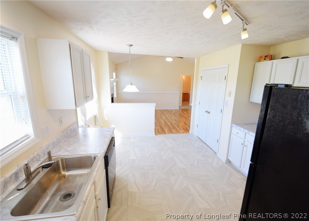 885 Ridge Road Fayetteville, NC 28311 - Photo 7 of 21 a view of a kitchen with furniture and a window