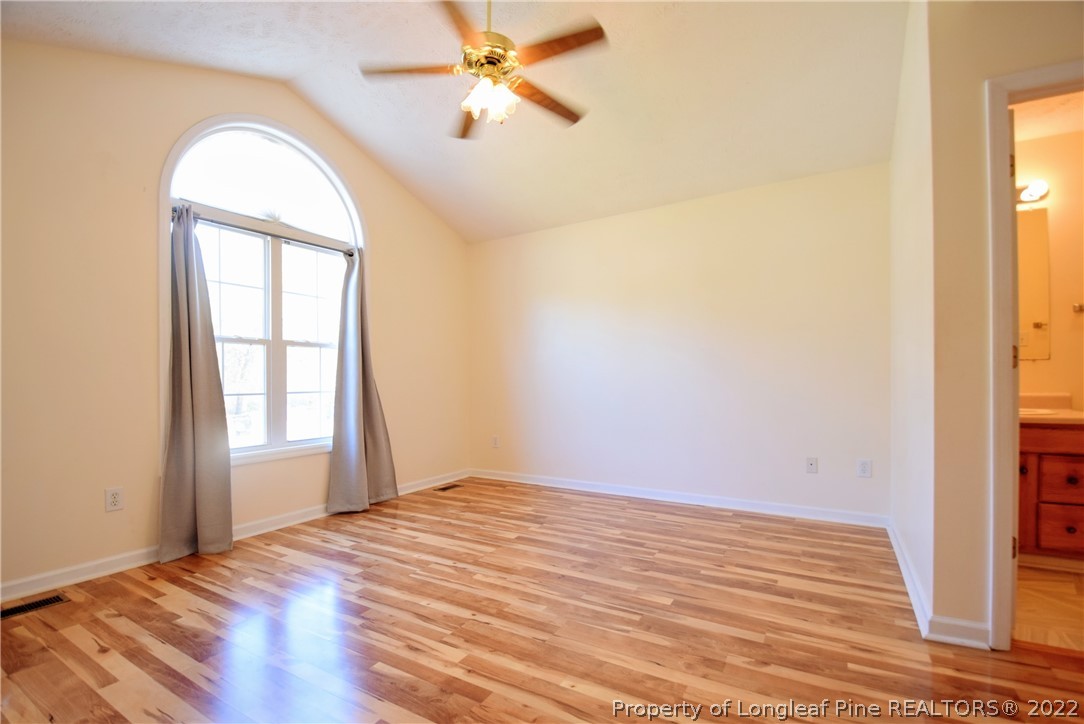 885 Ridge Road Fayetteville, NC 28311 - Photo 8 of 21 a view of empty room with wooden floor and fan