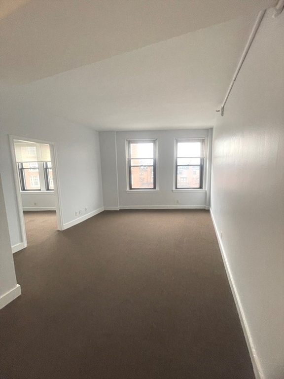 475 Commonwealth Avenue, Unit 606 Boston, MA 02215 - Photo 2 of 14 an empty room with windows