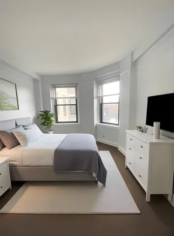 a spacious bedroom with a bed and window