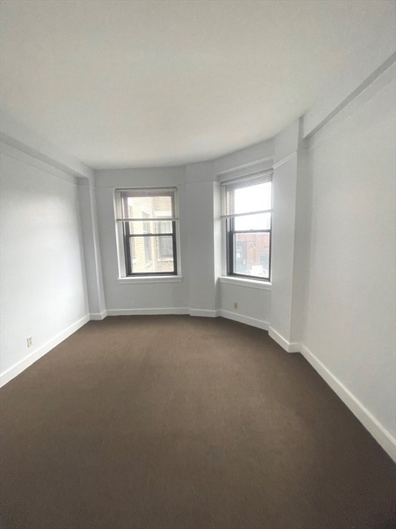 475 Commonwealth Avenue, Unit 606 Boston, MA 02215 - Photo 4 of 14 an empty room with windows