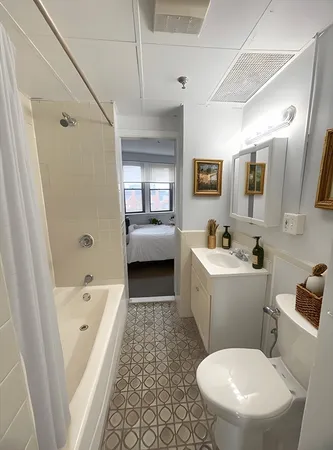 a bathroom with a sink a toilet and shower