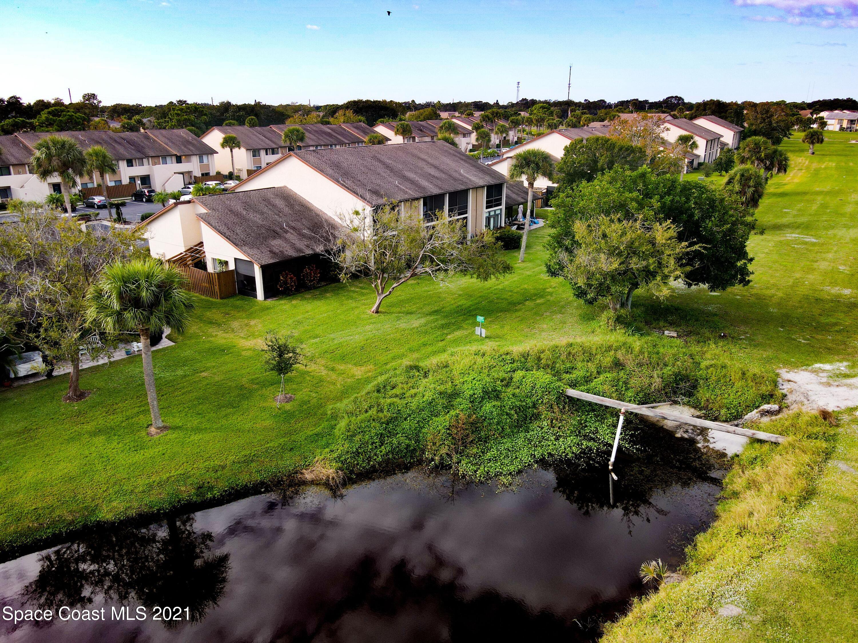 2210 Golf Isle Drive, Unit 906 Melbourne, FL 32935 - Photo 11 of 74 an aerial view of a house with a garden