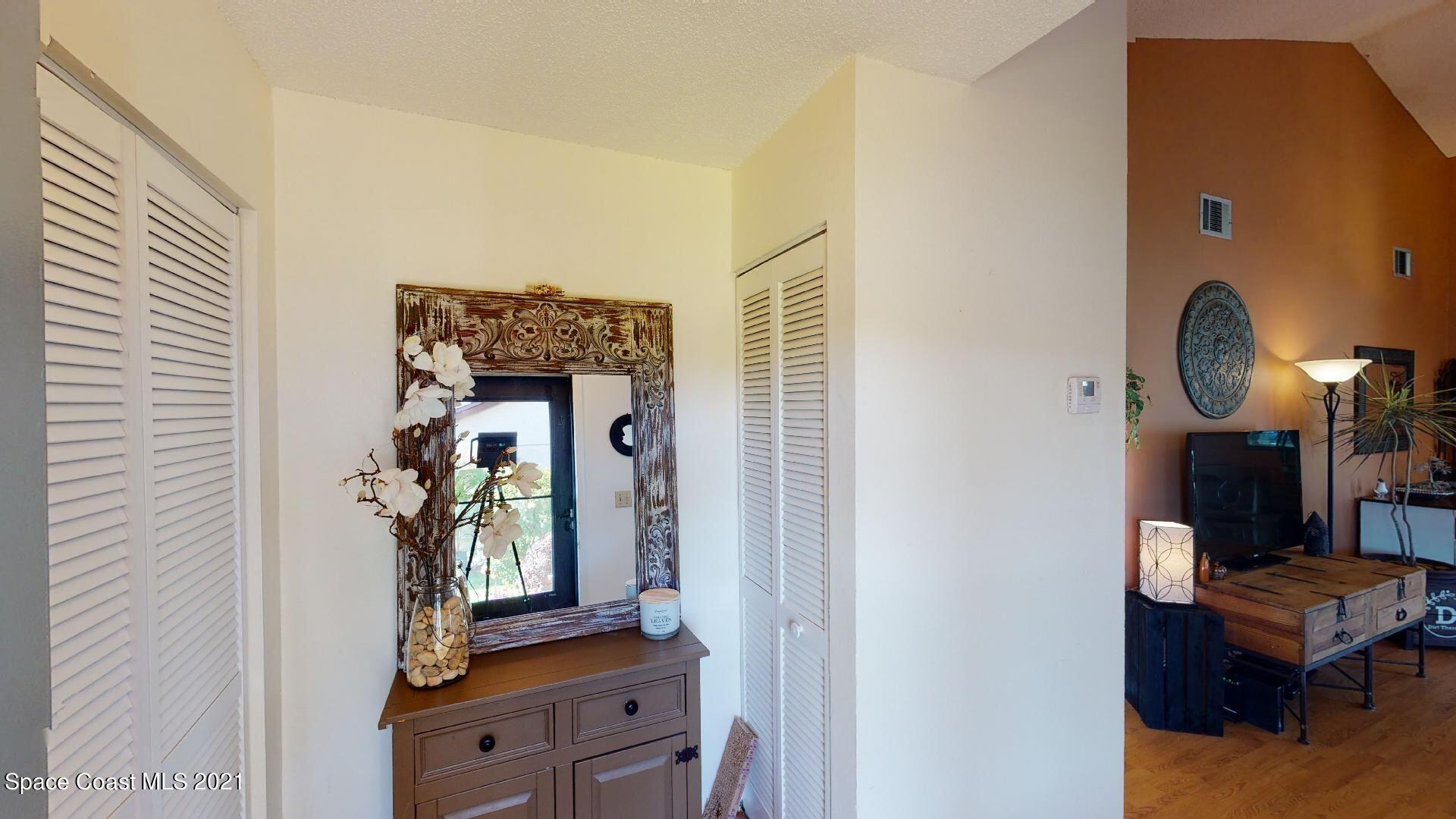 2210 Golf Isle Drive, Unit 906 Melbourne, FL 32935 - Photo 15 of 74 a view of living room with furniture and a mirror