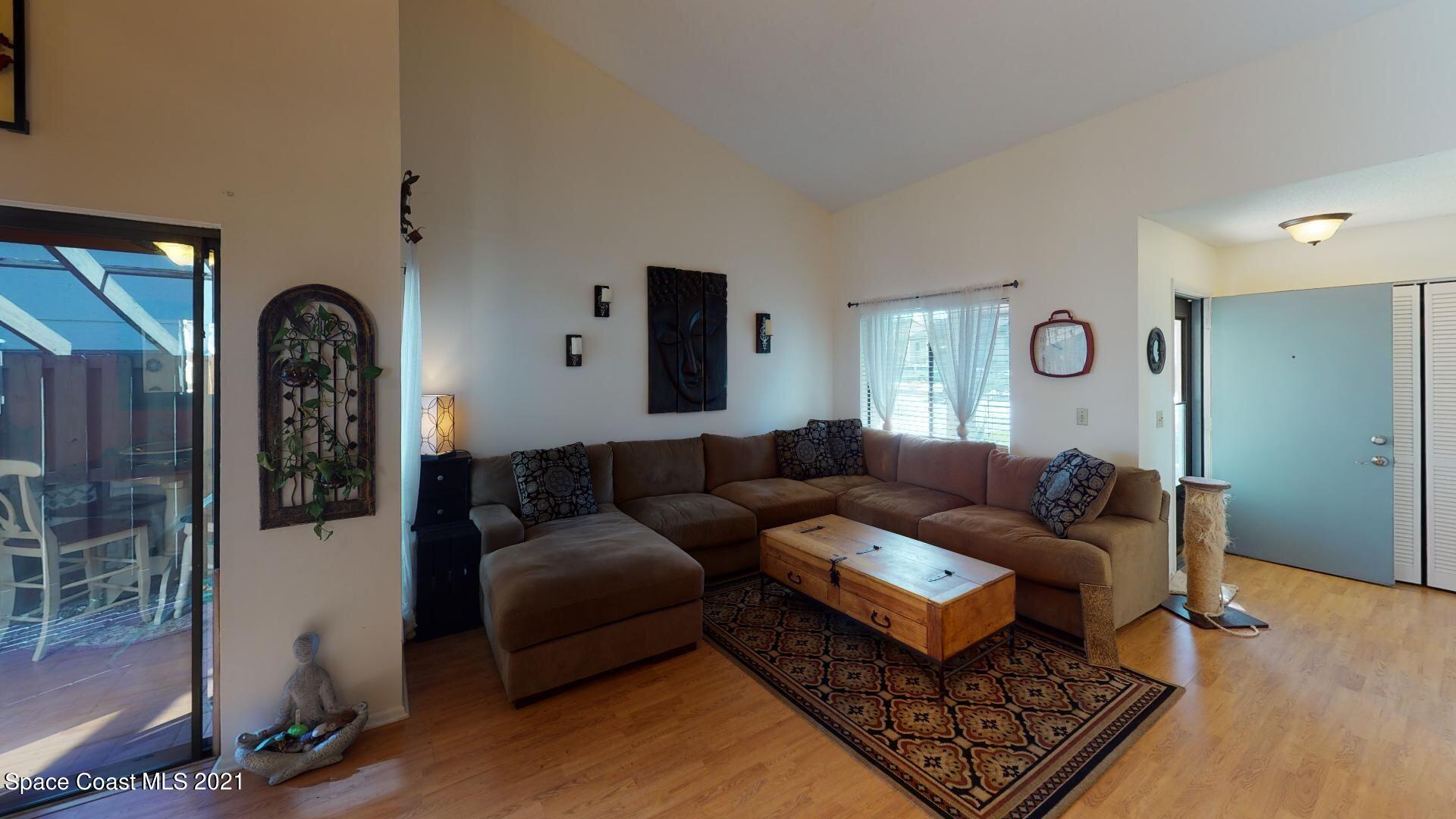 2210 Golf Isle Drive, Unit 906 Melbourne, FL 32935 - Photo 21 of 74 a living room with furniture and a rug