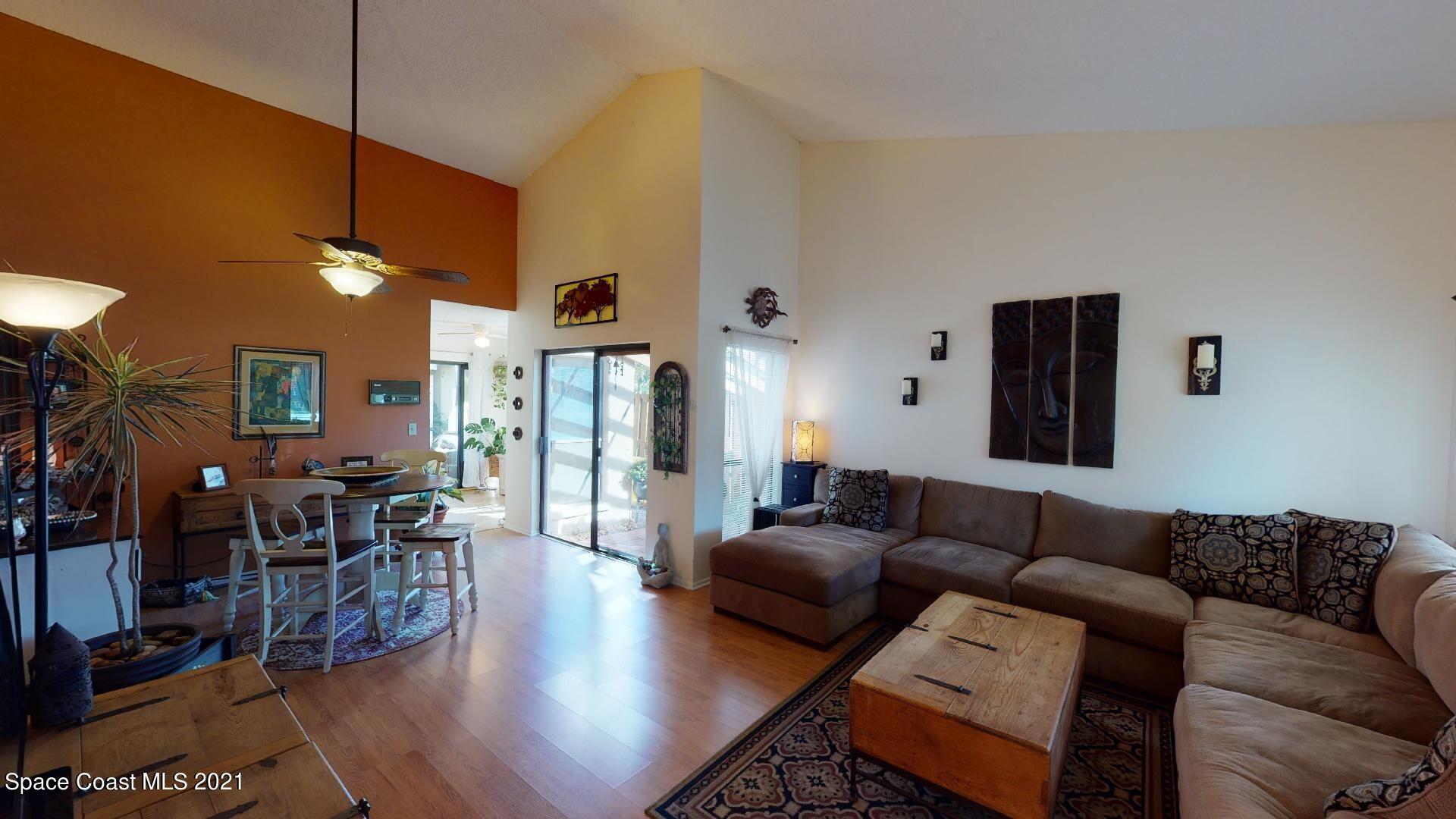 2210 Golf Isle Drive, Unit 906 Melbourne, FL 32935 - Photo 22 of 74 a living room with furniture and wooden floor