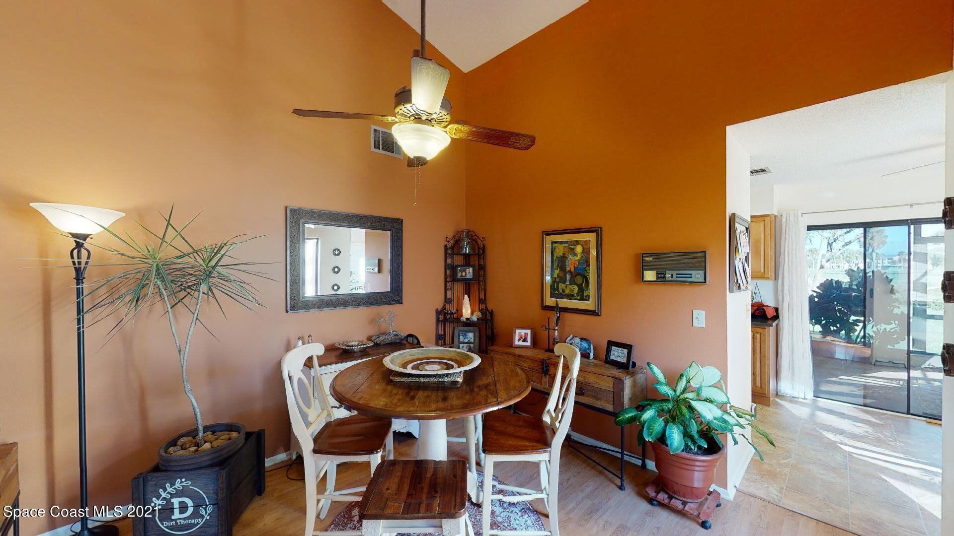 2210 Golf Isle Drive, Unit 906 Melbourne, FL 32935 - Photo 26 of 74 a view of a dining room and livingroom with furniture wooden floor and a chandelier