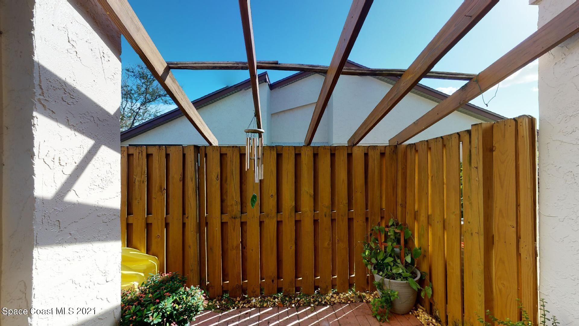 2210 Golf Isle Drive, Unit 906 Melbourne, FL 32935 - Photo 29 of 74 a view of a backyard with potted plants