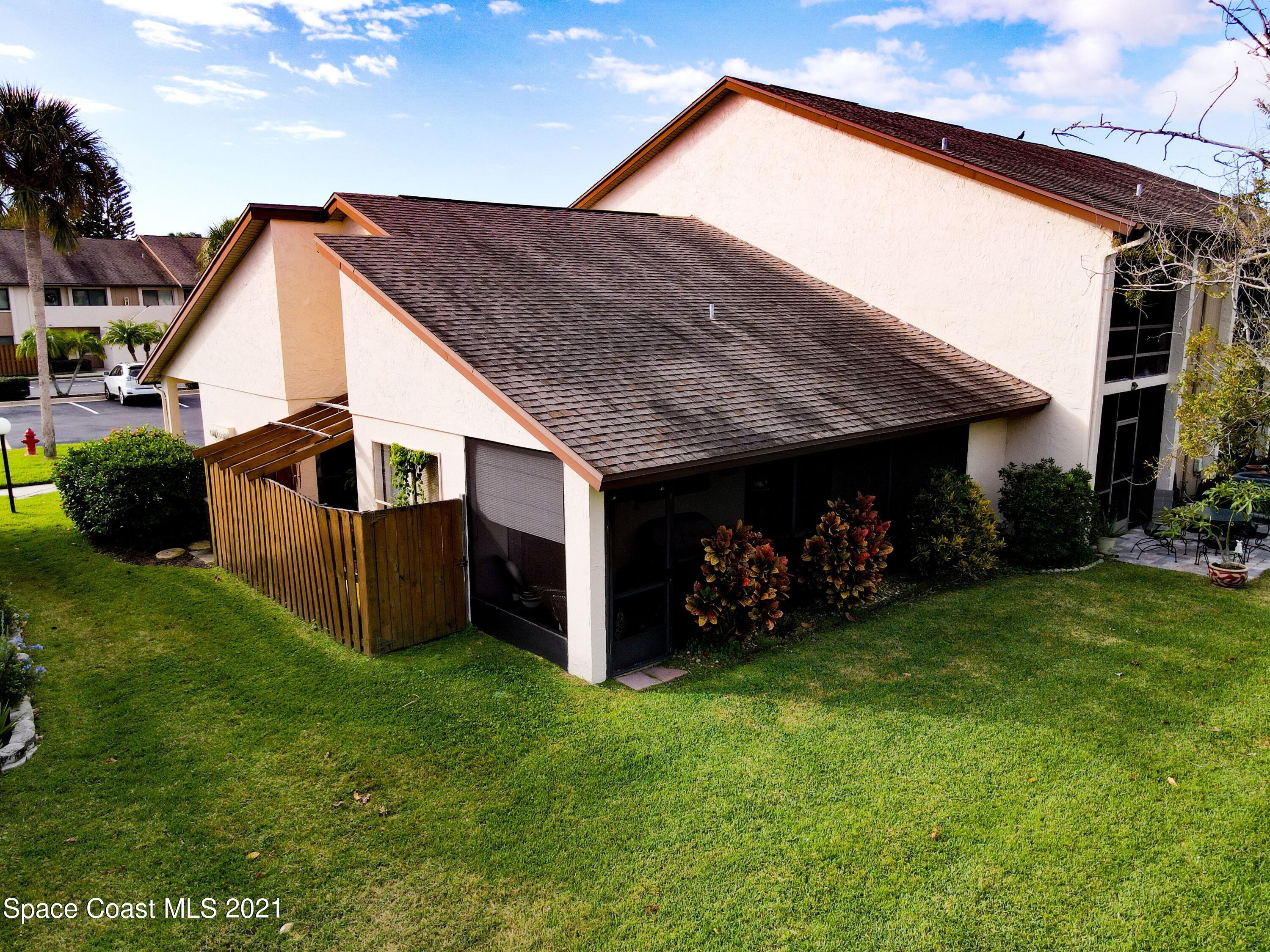 2210 Golf Isle Drive, Unit 906 Melbourne, FL 32935 - Photo 47 of 74 a view of a house with a yard plants and large tree