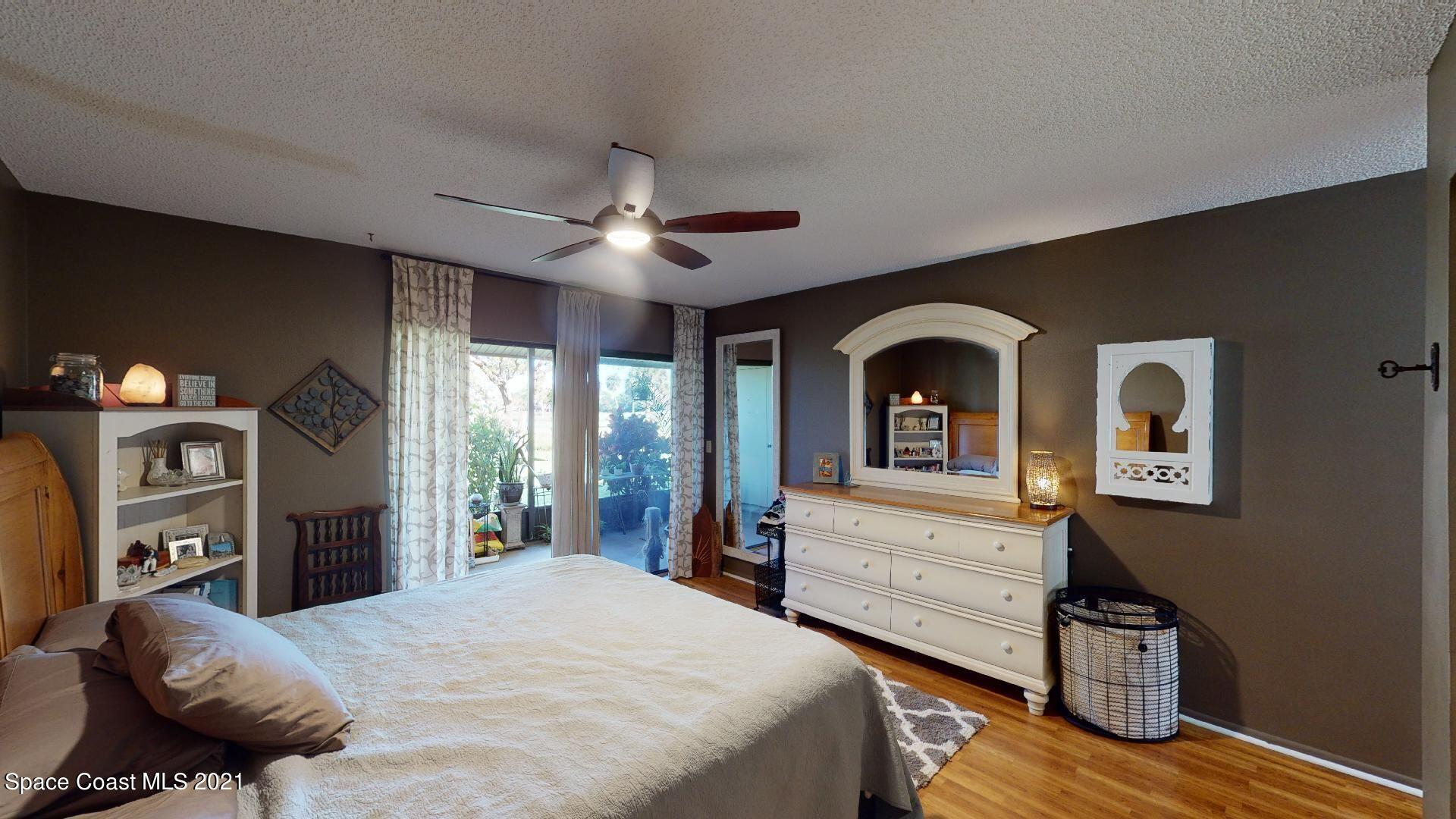 2210 Golf Isle Drive, Unit 906 Melbourne, FL 32935 - Photo 53 of 74 a bedroom with a bed and a with dresser