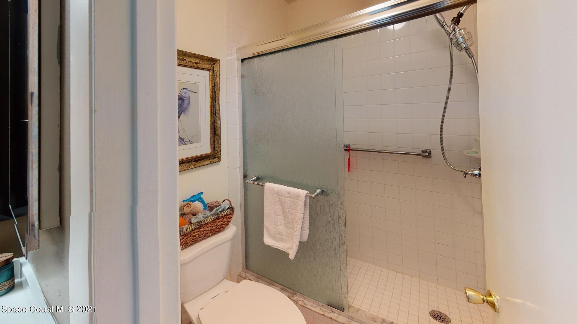 2210 Golf Isle Drive, Unit 906 Melbourne, FL 32935 - Photo 62 of 74 a bathroom with a toilet and a shower curtain