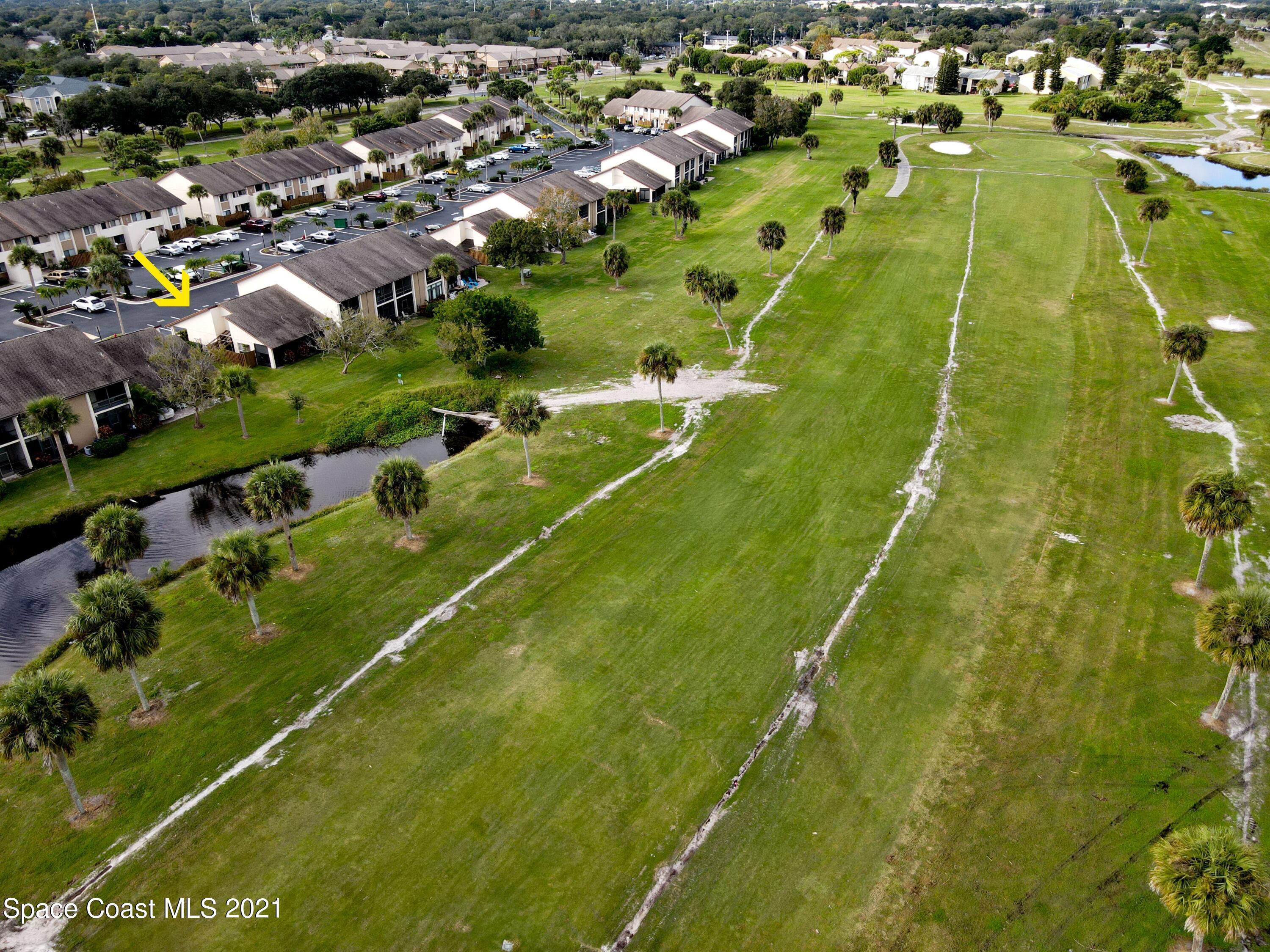 2210 Golf Isle Drive, Unit 906 Melbourne, FL 32935 - Photo 8 of 74 an aerial view of residential houses with outdoor space and trees