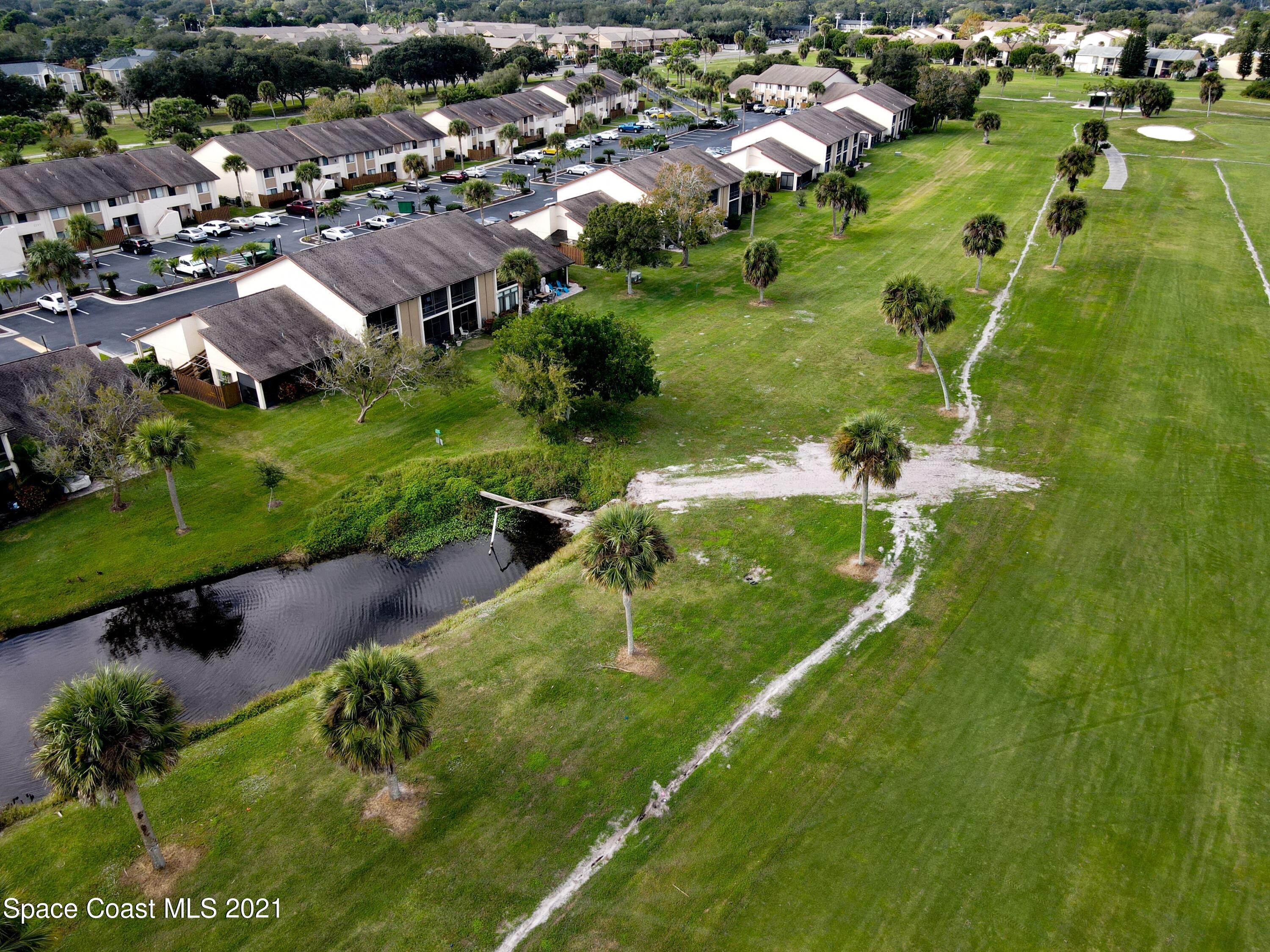 2210 Golf Isle Drive, Unit 906 Melbourne, FL 32935 - Photo 9 of 74 an aerial view of residential houses with outdoor space and trees