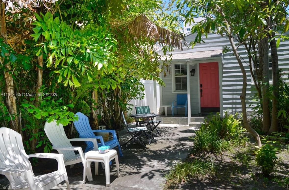 7611 Abbott Avenue, Unit R Miami Beach, FL 33141 - Photo 1 of 10 a backyard of a house with outdoor seating