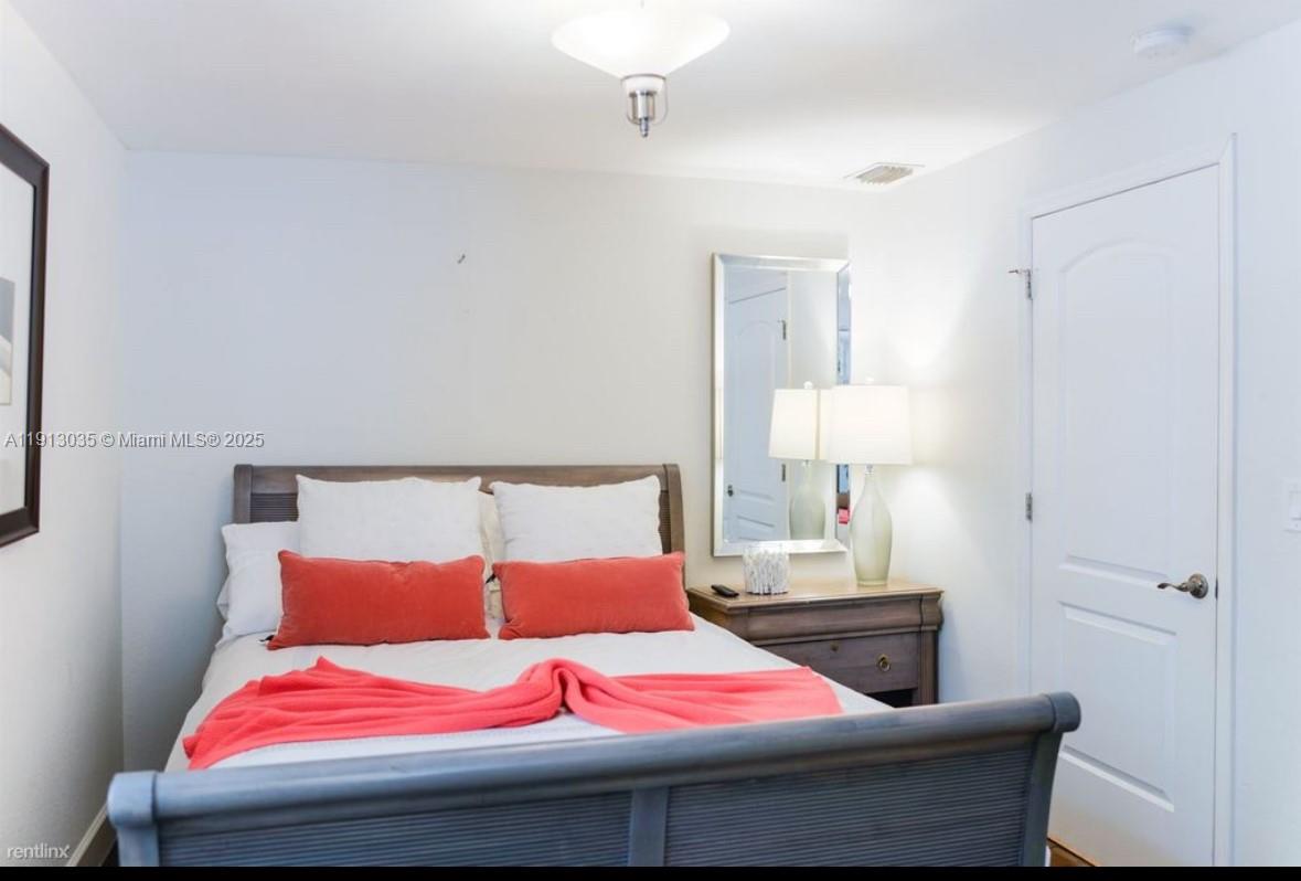 7611 Abbott Avenue, Unit R Miami Beach, FL 33141 - Photo 9 of 10 a bedroom with a bed and a window