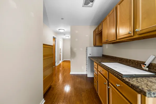a kitchen with stainless steel appliances granite countertop a sink and a stove