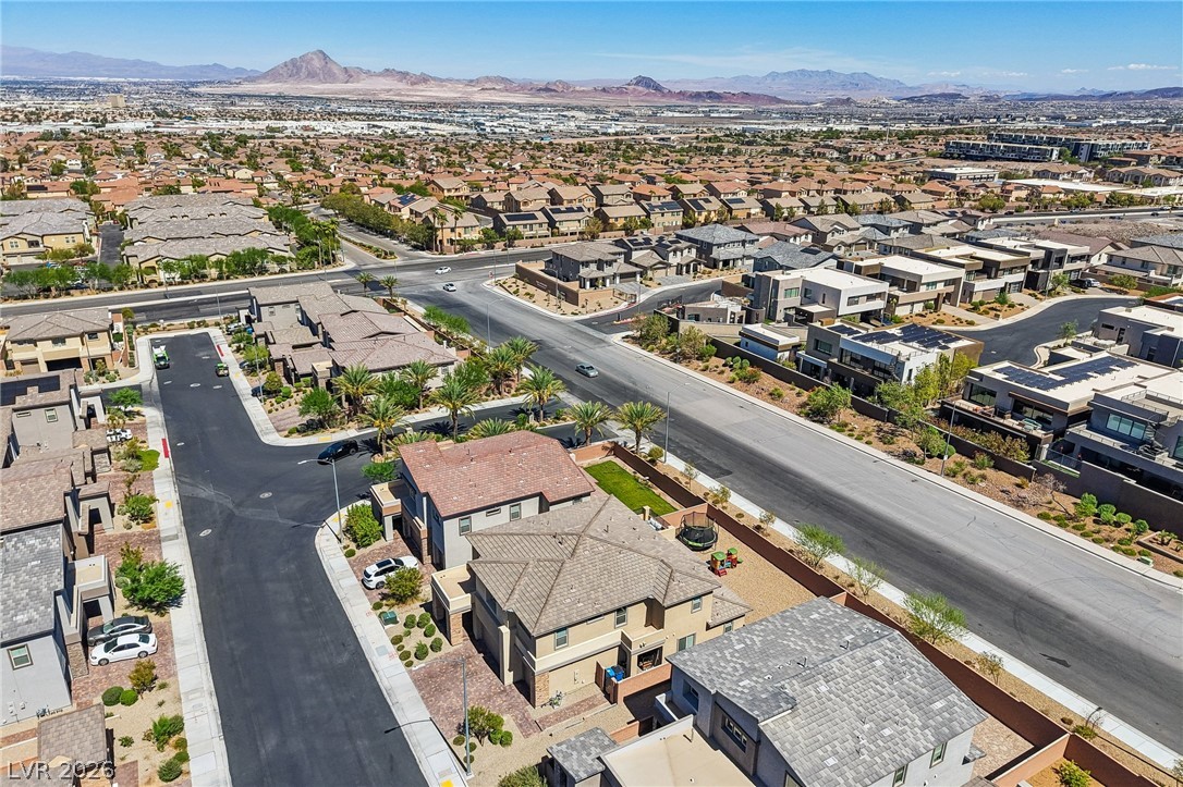 194 Viento Ridge Street Henderson, NV 89012 - Photo 64 of 72 Distant mountains frame a sweeping aerial perspective of this modern suburban neighborhood.
