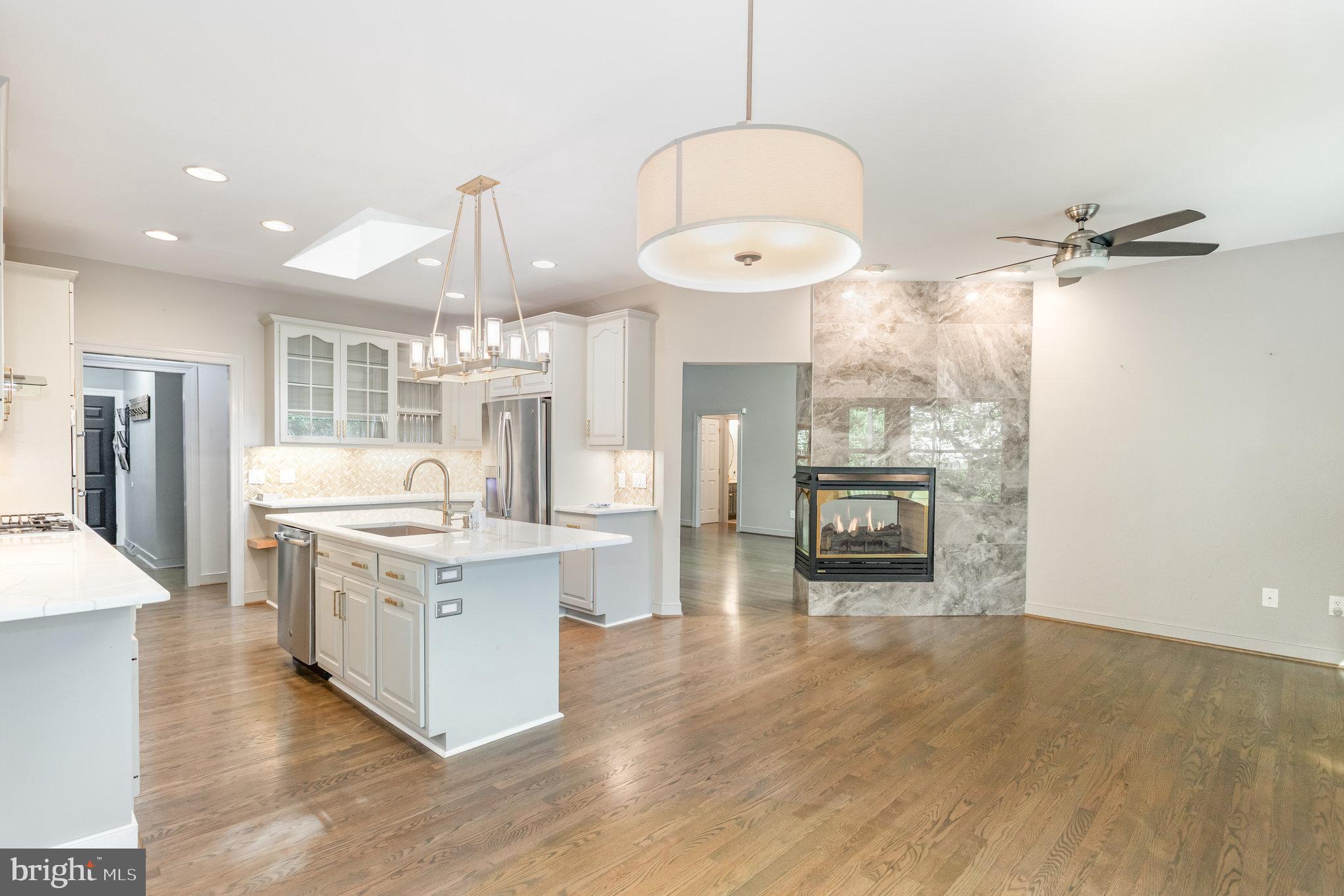 1817 Dogwood Road Harrisburg, PA 17110 - Photo 25 of 64 a large kitchen with stainless steel appliances a large counter top a stove and a chandelier
