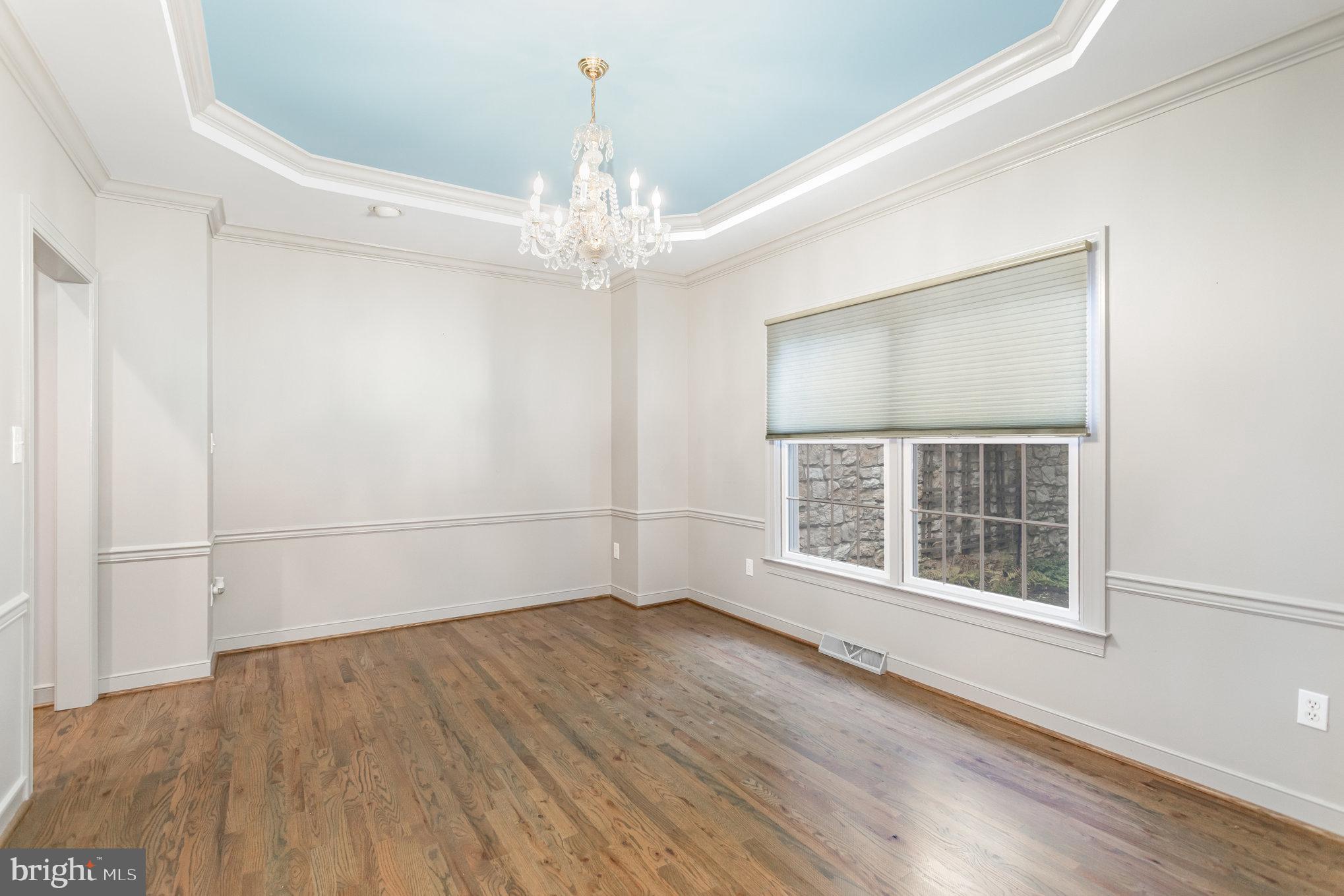 1817 Dogwood Road Harrisburg, PA 17110 - Photo 31 of 64 an empty room with wooden floor chandelier and windows