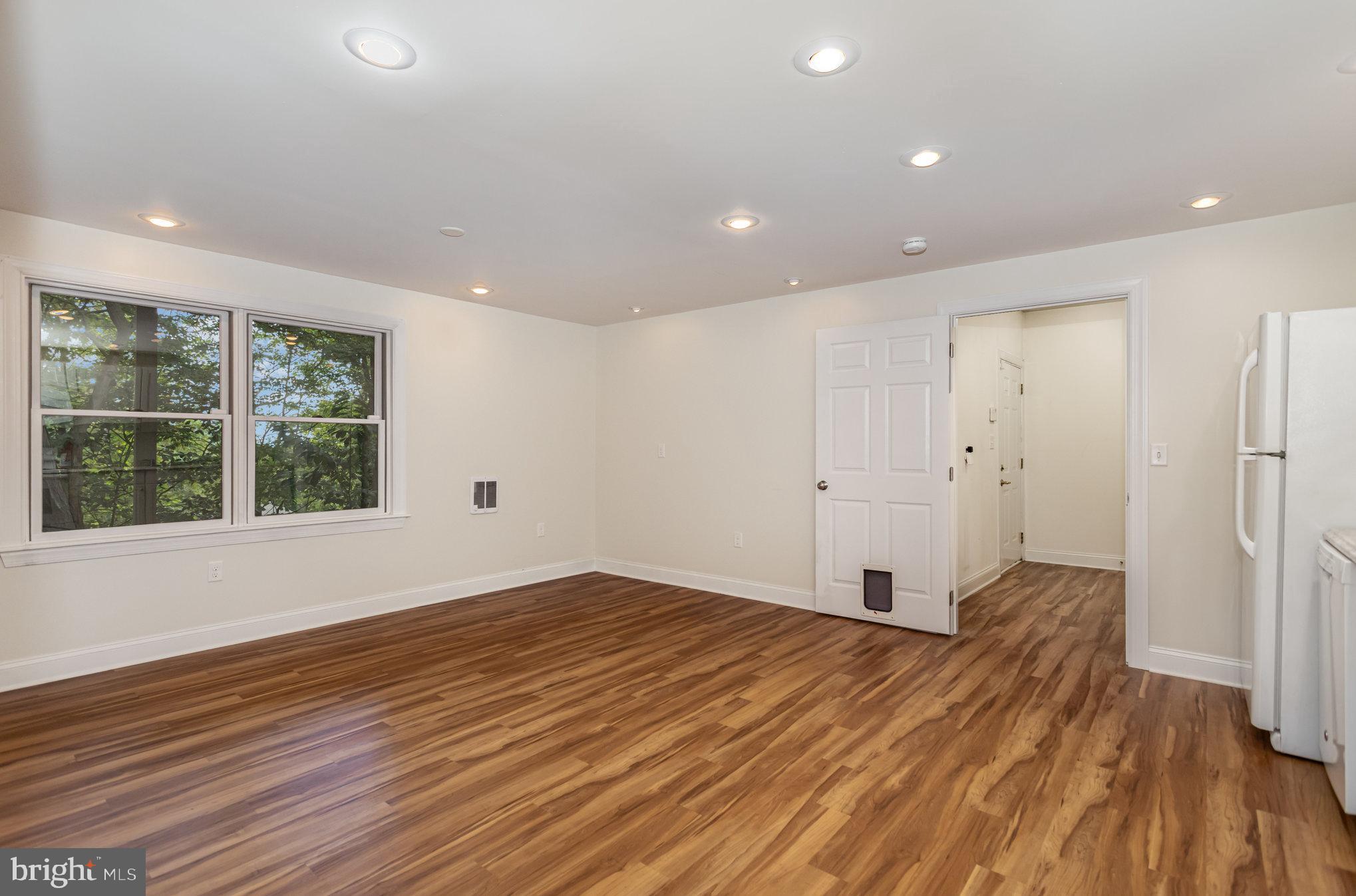 1817 Dogwood Road Harrisburg, PA 17110 - Photo 47 of 64 a view of an empty room with wooden floor and a window
