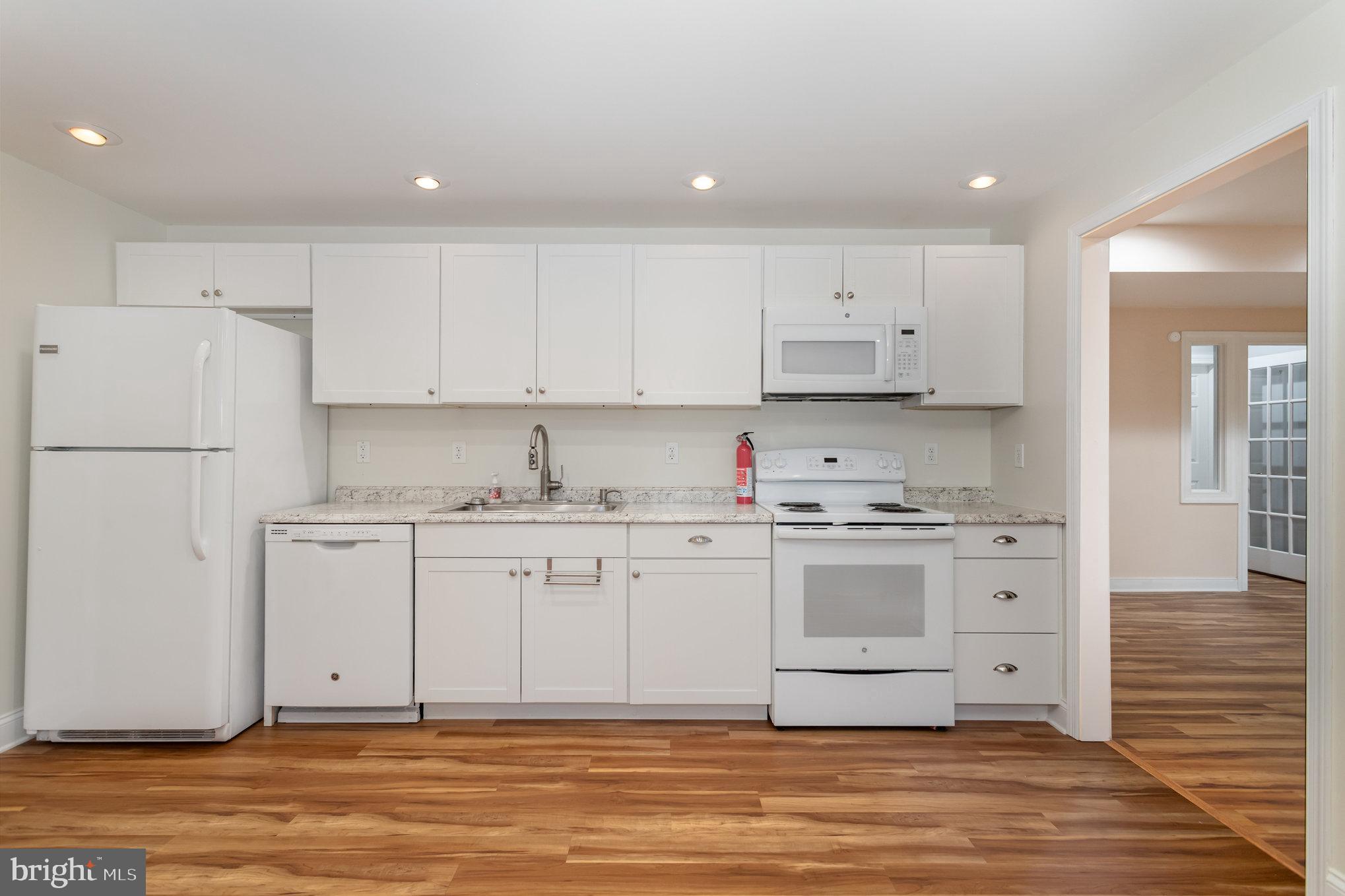 1817 Dogwood Road Harrisburg, PA 17110 - Photo 49 of 64 a kitchen with stainless steel appliances granite countertop a stove a sink and white cabinets