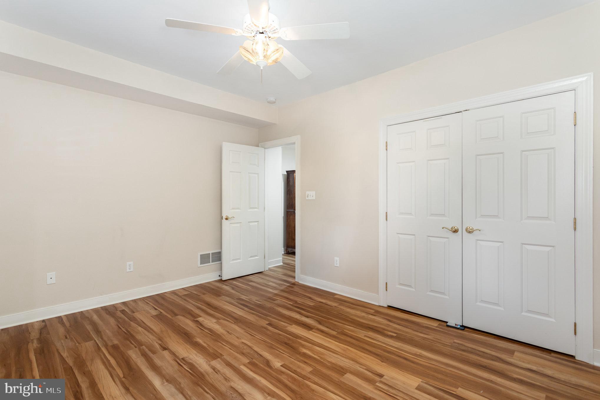1817 Dogwood Road Harrisburg, PA 17110 - Photo 51 of 64 wooden floor in an empty room with a chandelier fan